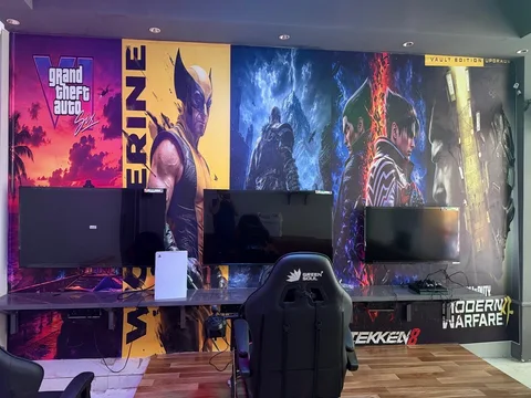 Gaming screens, seating and steering setup along the arena wall