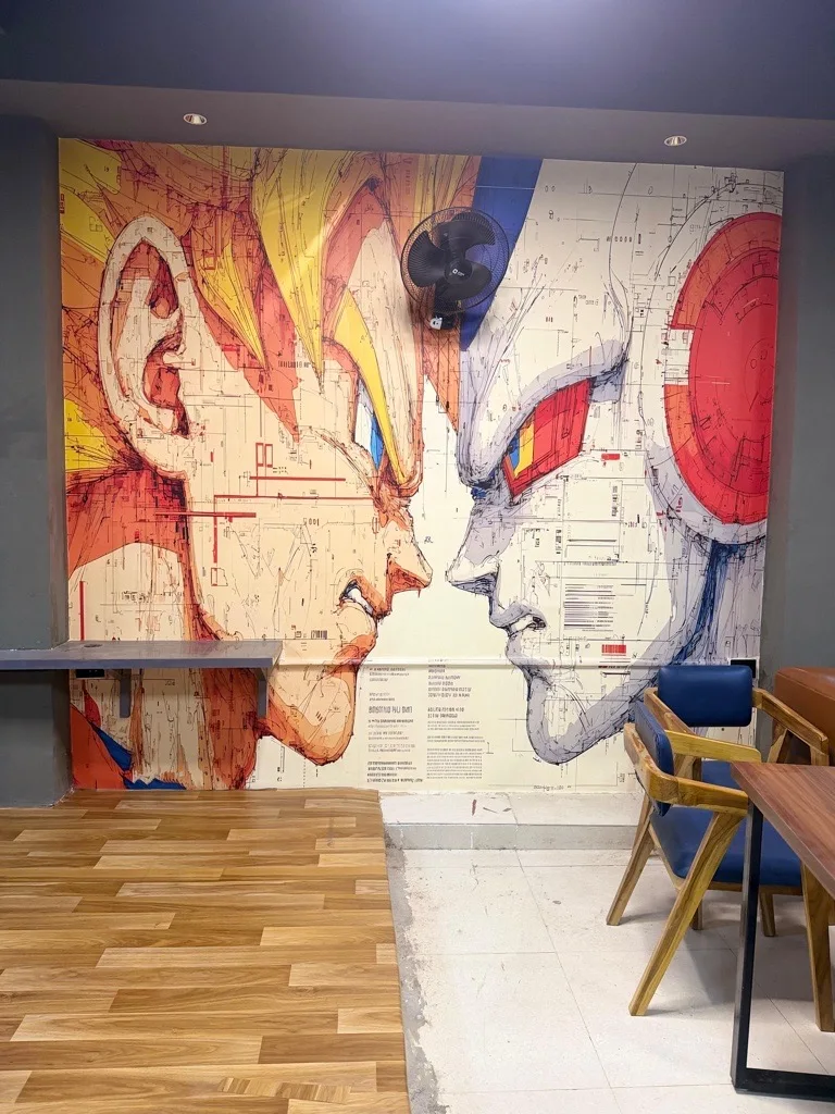 Cafe tables beside the illustrated walls at Legends Arena